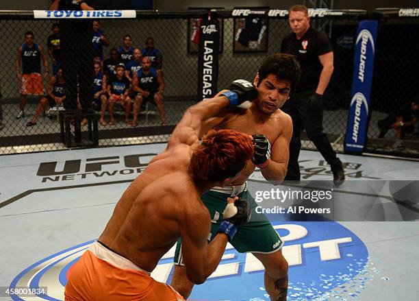 Team Werdum fighter Leonardo Morales punches team Velasquez fighter Gabriel Benitez in their semifinal fight during filming of The Ultimate Fighter...