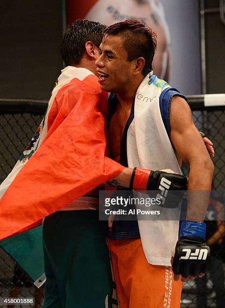 Team Werdum fighter Leonardo Morales hugs team Velasquez fighter Gabriel Benitez after their semifinal fight during filming of The Ultimate Fighter...