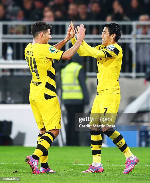 Shinji Kagawa of Dortmund is congratulated by Milos Jojic after scoring a goal during the DFB Cup match between FC St. Pauli and Borussia Dortmund at...