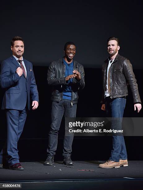 Actors Robert Downey Jr., Chadwick Boseman and Chris Evans onstage during Marvel Studios fan event at The El Capitan Theatre on October 28, 2014 in...