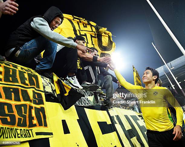 Shinji Kagawa of Dortmund is congratulated by the fans after the DFB Cup match between FC St. Pauli and Borussia Dortmund at Millerntor Stadium on...