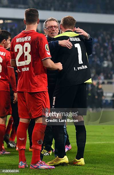 Timo Horn of Koeln celebrates with head coach Peter Stoeger after winning the DFB Cup second round match between MSV Duisburg and 1. FC Koeln at...