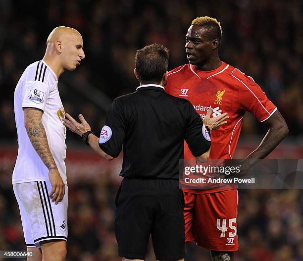 Mario Balotelli of Liverpool and Jonjo Shelvey of Swansea City clash during the Capital One Cup Fourth Round match between Liverpool and Swansea City...