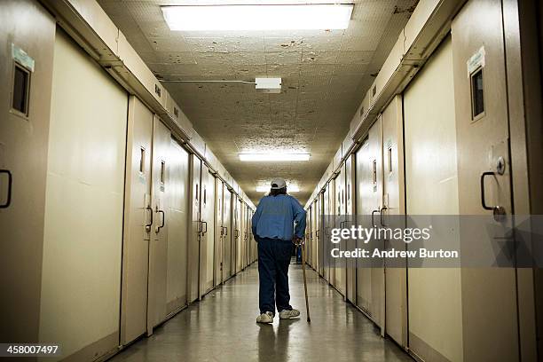 Frank Fuller, age 66, walks back to his prison cell after taking medication at California Men's Colony prison on December 19, 2013 in San Luis...