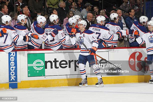 Taylor Hall of the Edmonton Oilers is congratulated by teammates after scoring a first period goal against the Colorado Avalanche at the Pepsi Center...