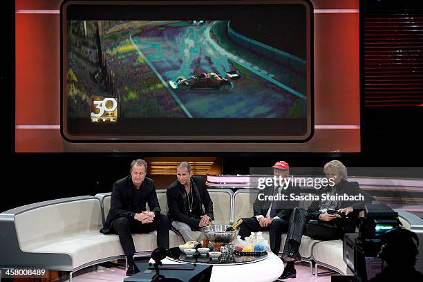 Florian Koenig, Kai Ebel, Niki Lauda and Thomas Gottschalk watch the accident scene of the film 'Rush' during the taping of the anniversary show '30...