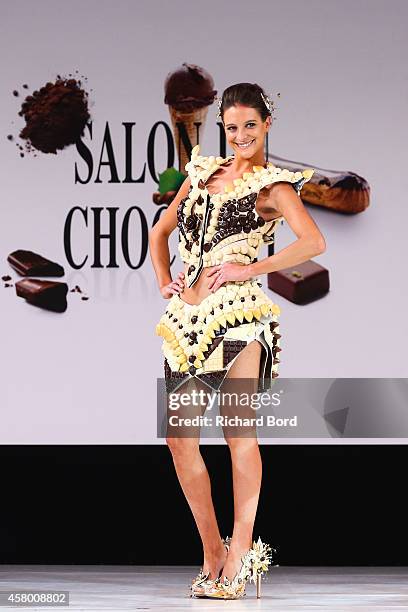 Nubia Esteban walks the runway and wears a chocolate dress made by designer Benjamin Bout and chocolate brand Chocolaterie de Puyricard during the...