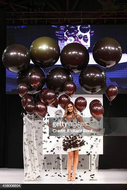 Clara Morgane walks the runway and wears a chocolate dress made by designer Fanny Liautard and chocolate maker Henry Le Roux during the Fashion...