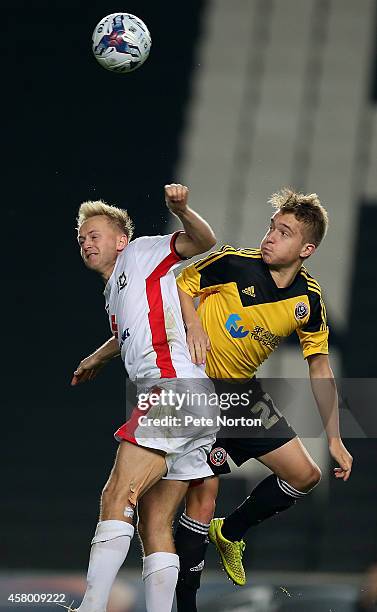 Ben Reeves of MK Dons contests the with Terry Kennedy of Sheffield United during the Capital One Cup Fourth Round match between MK Dons and Sheffield...