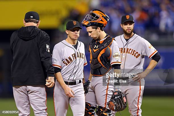 Jake Peavy of the San Francisco Giants walks to the dugout after getting pulled from the game in the second inning as manager Bruce Bochy, Buster...
