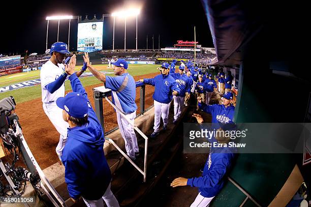 Alcides Escobar of the Kansas City Royals celebrates in the dugout after scoring in the second inning against the San Francisco Giants during Game...
