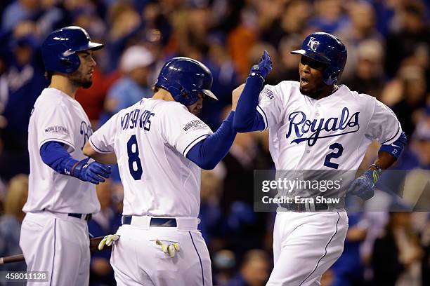 Alcides Escobar of the Kansas City Royals celebrates with Mike Moustakas after scoring in the second inning against the San Francisco Giants during...