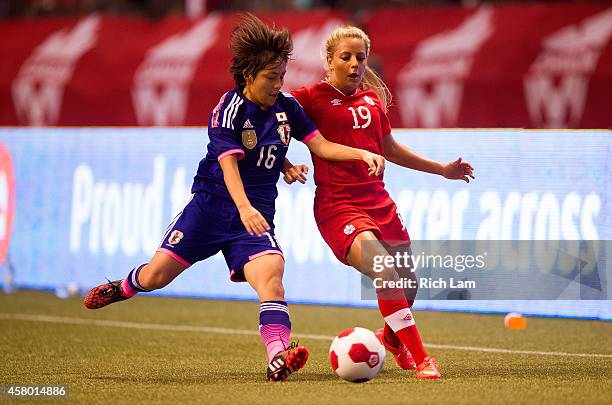 Mana Iwabuchi of Japan knocks the ball away from Adriana Leon of Canada in Women's International Soccer Friendly Series action on October 28, 2014 at...