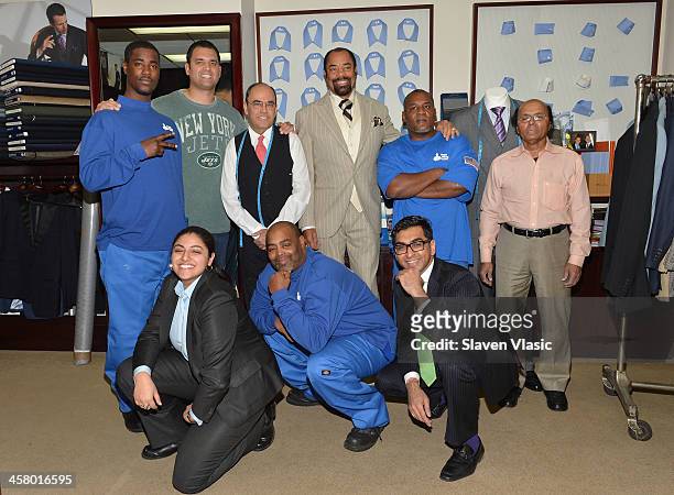 Former Jets player Anthony Becht , Mohan Ramchandani and former basketball player Walt "Clyde" Frasier with Doe Fund program members/recipients of a...