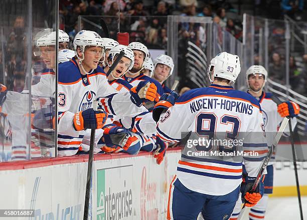 Ryan Nugent-Hopkins of the Edmonton Oilers is congratulated by teammates after scoring against the Colorado Avalanche at the Pepsi Center on December...