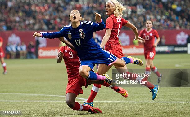 Yuki Ogimi of Japan keeps an eye on the ball after getting tackled by Kadeisha Buchanan of Canada in Women's International Soccer Friendly Series...