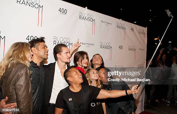 Publicist Rembrandt Flores takes a selfie with actress Kristin Bauer van Straten, director Francis dela Torre, actor Alexander Dreymon and actresses...