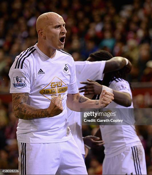 Jonjo Shelvey of Swansea celebrates Marvin Emnes's opening goal during the Capital One Cup Fourth Round match between Liverpool and Swansea City at...