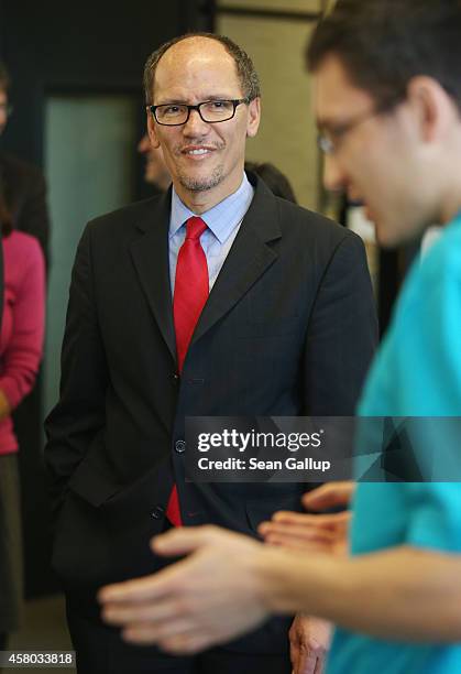 Labor Secretary Thomas Perez chats with trainees at the Siemens training facility on October 28, 2014 in Berlin, Germany. Secretary Perez visited the...