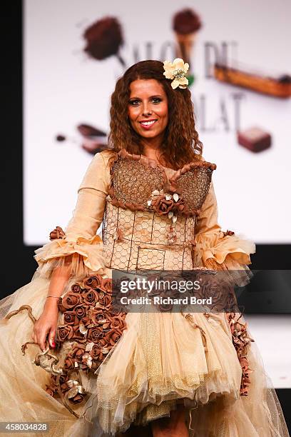 Myriam Seurat walks the runway and wears a chocolate dress made by pastry chef Elodie Martins and fashion brand Mademoiselle P. During the Fashion...