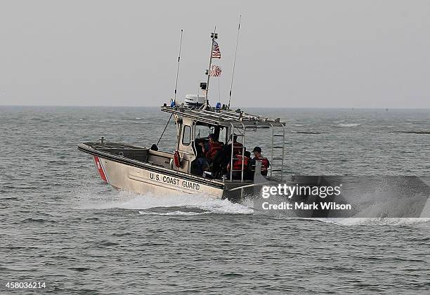 Coast Guard boat patrols the waters near NASA's Wallops Flight Facility, October 29, 2014 in Chincoteague Island, Virginia. Last night an unmanned...