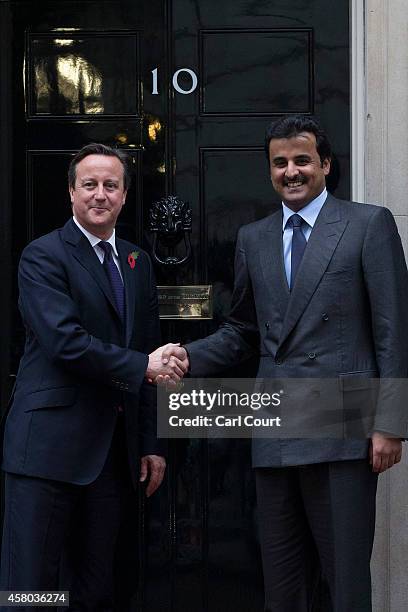 British Prime Minister David Cameron greets Sheikh Tamim bin Hamad Al Thani, the Emir of Qatar, at Downing Street on October 29, 2014 in London,...