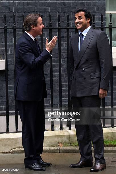 British Prime Minister David Cameron greets Sheikh Tamim bin Hamad Al Thani, the Emir of Qatar, at Downing Street on October 29, 2014 in London,...