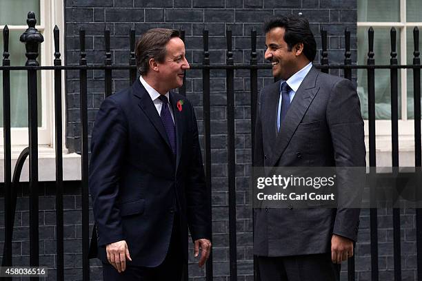 British Prime Minister David Cameron greets Sheikh Tamim bin Hamad Al Thani, the Emir of Qatar, at Downing Street on October 29, 2014 in London,...