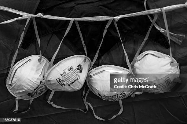 Face masks are seen hanging from a tent on the street outside the Hong Kong Government Complex on October 23, 2014 in Hong Kong, Hong Kong. One month...