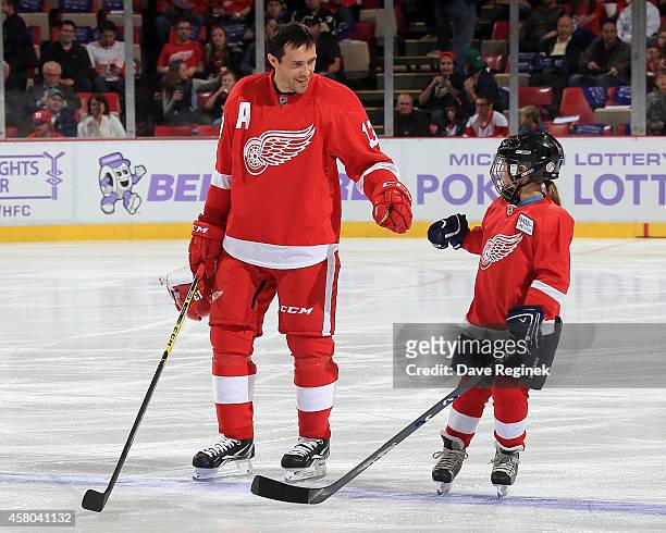 Pavel Datsyuk of the Detroit Red Wings greets the youth player of the game on "Hockey Fights Cancer" night, Abby Pieper before a NHL game against the...