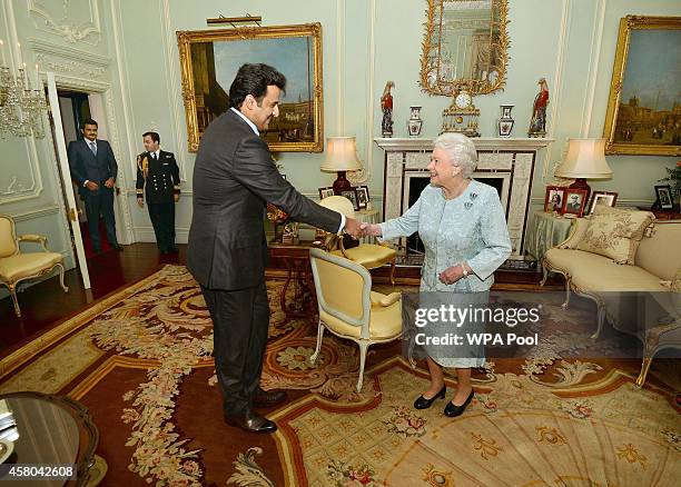 Queen Elizabeth II shakes hands with Emir of Qatar, Sheikh Tamim bin Hamad Al Thani during a private audience at Buckingham Palace on January 29,...
