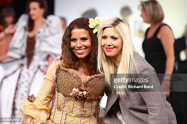 Myriam Seurat walks the runway with pastry chef Elodie Martins during the Fashion Chocolate show at Salon du Chocolat at Parc des Expositions Porte...