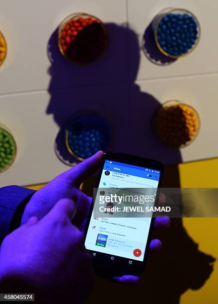 Google's lead designer for "Inbox by Gmail" Jason Cornwell shows the app's functionalities on a nexus 6 android phone during a media preview in New...