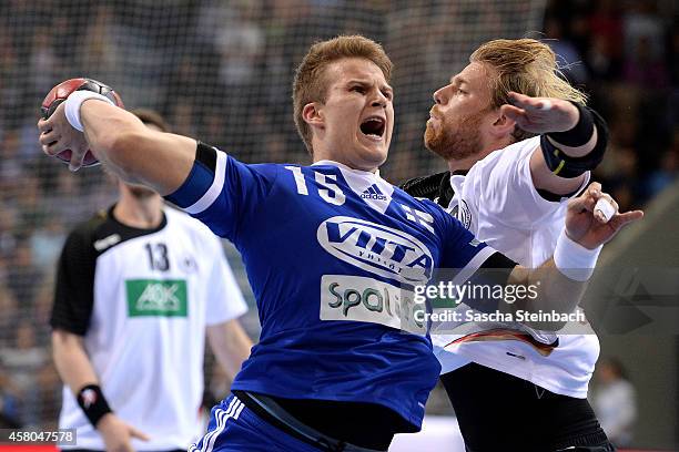 Manuel Spaeth of Germany is challenged by Richard Sundberg of Finland during the 2016 European Men's Handball Championship qualifier match between...