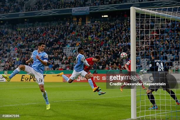 Admir Mehmedi of Freiburg scores the third team goal against Martin Angha of Muenchen and his keeper Stefan Ortega during the DFB Cup second round...