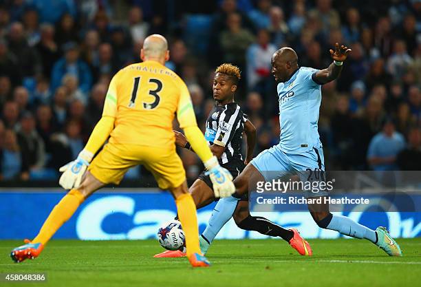 Rolando Aarons of Newcastle United scores the opening goal under pressure from Eliaquim Mangala of Manchester City during the Capital One Cup Fourth...