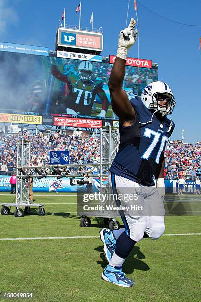 Chance Warmack of the Tennessee Titans runs onto the field before a game against the Houston Texans at LP Field on October 26, 2014 in Nashville,...