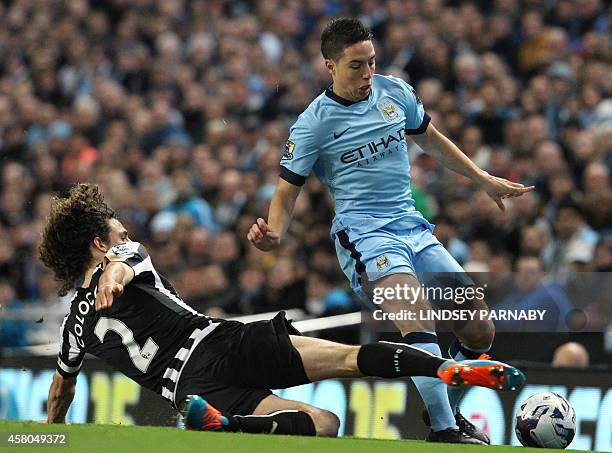 Newcastle United's Argentinian defender Fabricio Coloccini vies with Manchester City's French midfielder Samir Nasri during the English League Cup...