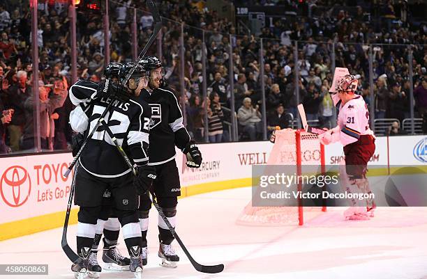 Trevor Lewis, Tyler Toffoli and Dwight King of the Los Angeles Kings celebrate Toffoli's second period goal as goaltender Antti Niemi of the San Jose...