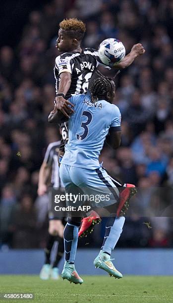 Newcastle United's Jamaican midfielder Rolando Aarons vies with Manchester City's French defender Bacary Sagna during the English League Cup fourth...