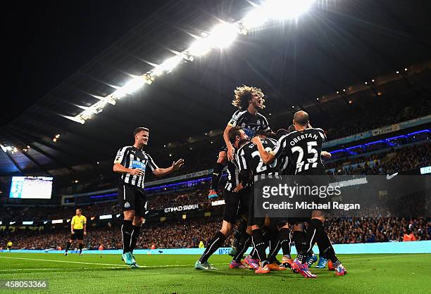 Moussa Sissoko of Newcastle United is mobbed by team mates after scoring their second goal during the Capital One Cup Fourth Round match between...