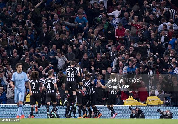 Teammates and fans celebrate Newcastle United's French midfielder Moussa Sissoko's goal during the English League Cup fourth round football match...