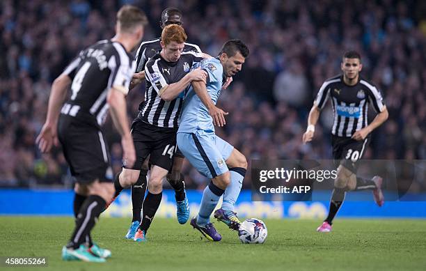 Newcastle United's English midfielder Jack Colback vies with Manchester City's Argentinian striker Sergio Aguero during the English League Cup fourth...