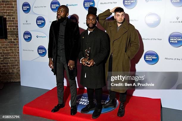 Alloysious Massaquoi, 'G' Hastings and Kayus Bankole of Young Fathers pose in the winners room at the Barclaycard Mercury Prize at The Roundhouse on...