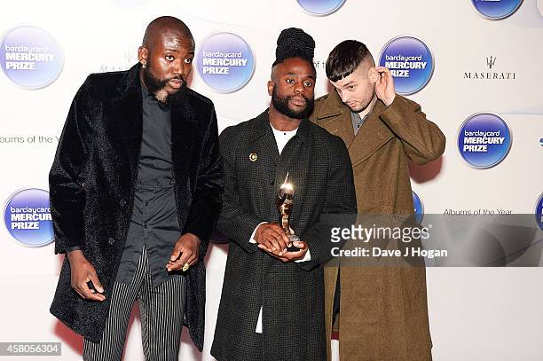 Winners of the Barclaycard Mercury Prize Alloysious Massaquoi, 'G' Hastings and Kayus Bankole of Young Fathers pose in the winners room at the...