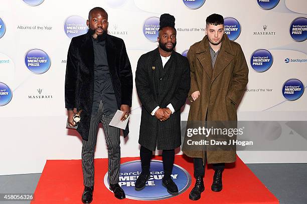 Winners of the Barclaycard Mercury Prize Alloysious Massaquoi, 'G' Hastings and Kayus Bankole of Young Fathers pose in the winners room at the...