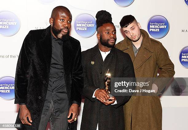 Winners of the Barclaycard Mercury Prize Alloysious Massaquoi, 'G' Hastings and Kayus Bankole of Young Fathers pose in the winners room at the...