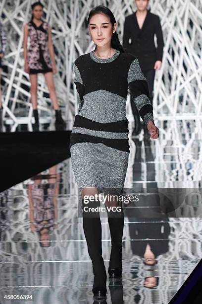 Model showcases designs on the runway at GIOIA PAN Collection show during the fourth day of the Mercedes-Benz China Fashion Week Spring/Summer 2015...