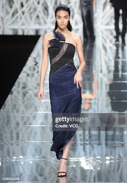 Model showcases designs on the runway at GIOIA PAN Collection show during the fourth day of the Mercedes-Benz China Fashion Week Spring/Summer 2015...