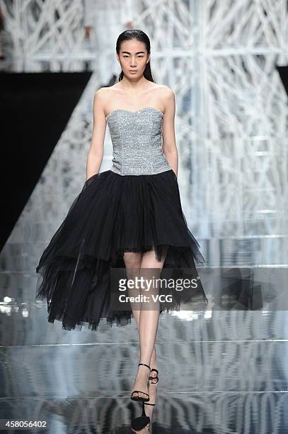 Model showcases designs on the runway at GIOIA PAN Collection show during the fourth day of the Mercedes-Benz China Fashion Week Spring/Summer 2015...